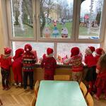 dzieci obserwują Mikołaja przez okno