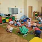 dzieci kładą głowę na piłkach